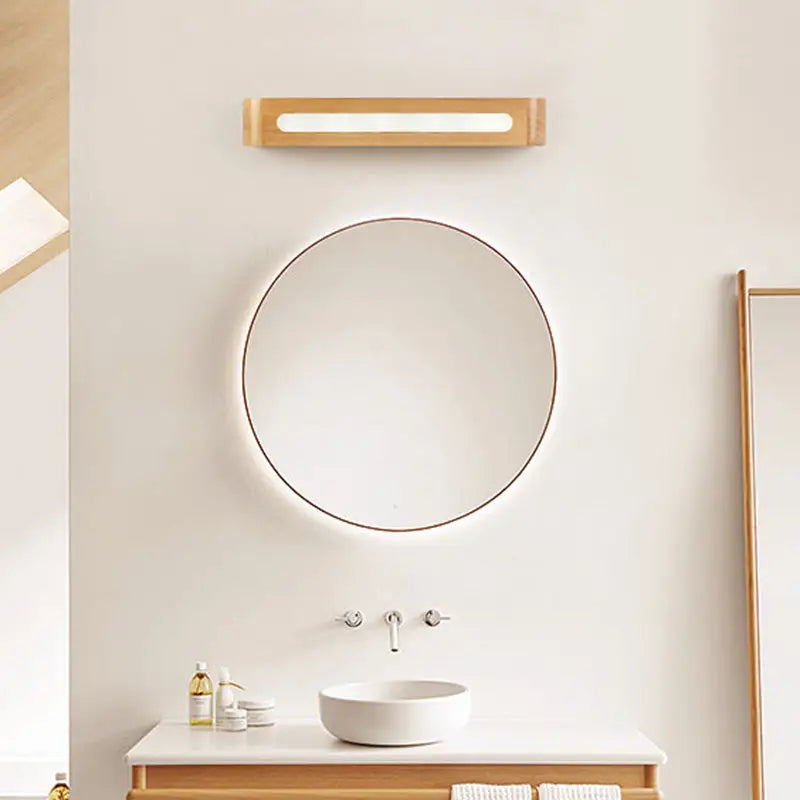 Minimalist round mirror with thin metallic frame paired with nordic style bamboo led wall sconce for bedroom lighting