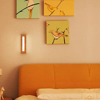 A minimalist bamboo led wall sconce with warm glow and wooden frame in nordic style for bedroom lighting with max bulb wattage