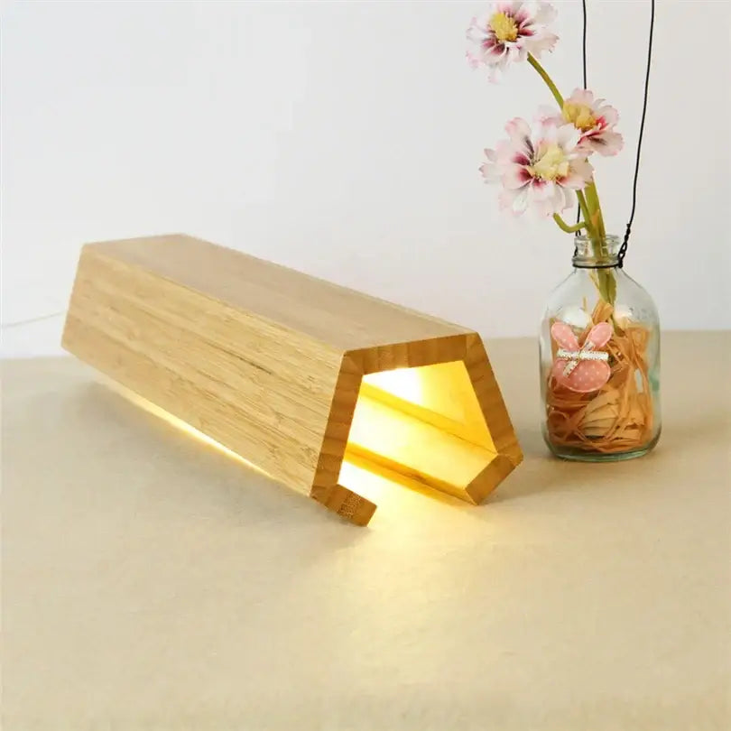 Minimalist decorbites bamboo pentagonal led desk lamp in light brown with warm yellow glow for bedroom reading