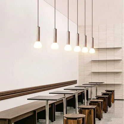 Six minimalist beige and white glass stone led pendant lights with cylindrical concrete shades for kitchen decorbites lighting