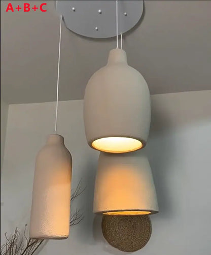Minimalist beige cement chandelier light with three matte off-white ceramic pendant lights for living room decorbites cement chandelier