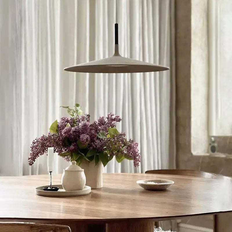Beige minimalist cement ufo led pendant light with black suspension rod for dining room decorbites pendant lights