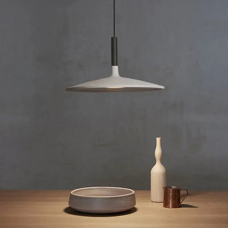 Minimalist beige cement ufo led pendant light with white ceramic disc shade and matte black rod for dining room decorbites pendant lights