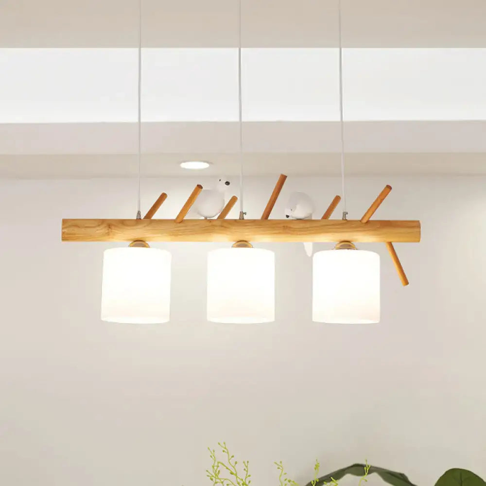 Decorbites™ beige drum island lighting features a wooden pendant lamp with three white glass shades and bird branch design