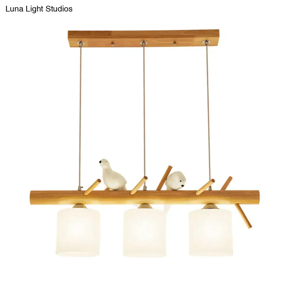 DecorBites beige drum island lighting with wooden pendant, frosted glass shades, and ceramic birds on bamboo mount