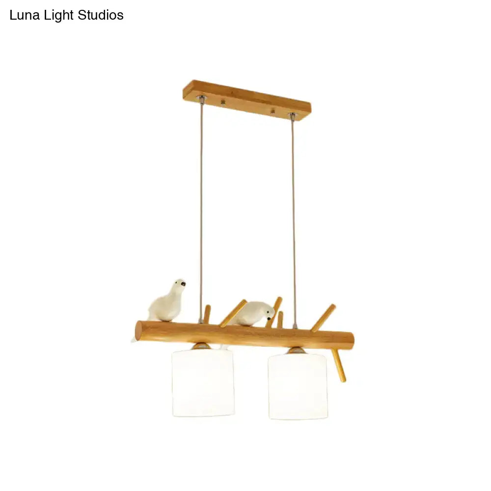Beige drum island lighting featuring a minimalist wooden pendant with white ceramic birds and frosted glass shades