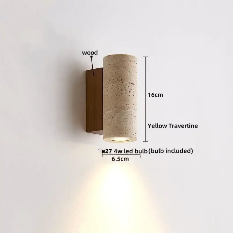 A modern minimalist cylindrical led wall light with yellow travertine body and wooden backplate for bedroom use
