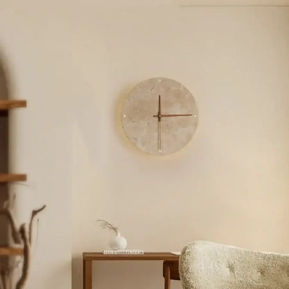 Minimalist beige travertine stone wall clock with textured face and slender metallic hands for led wall lights decor
