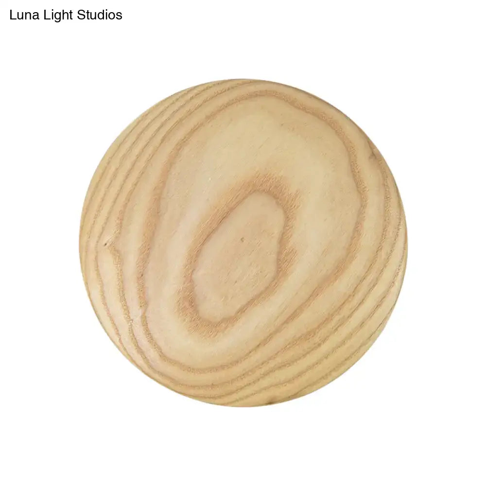 Minimalist beige wood circle led bulb wall sconce with round light-colored wooden knob and natural grain finish