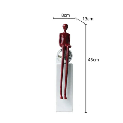A sleek glossy red metal figurine abstract thinker with elongated limbs on a reflective sphere for living room decor