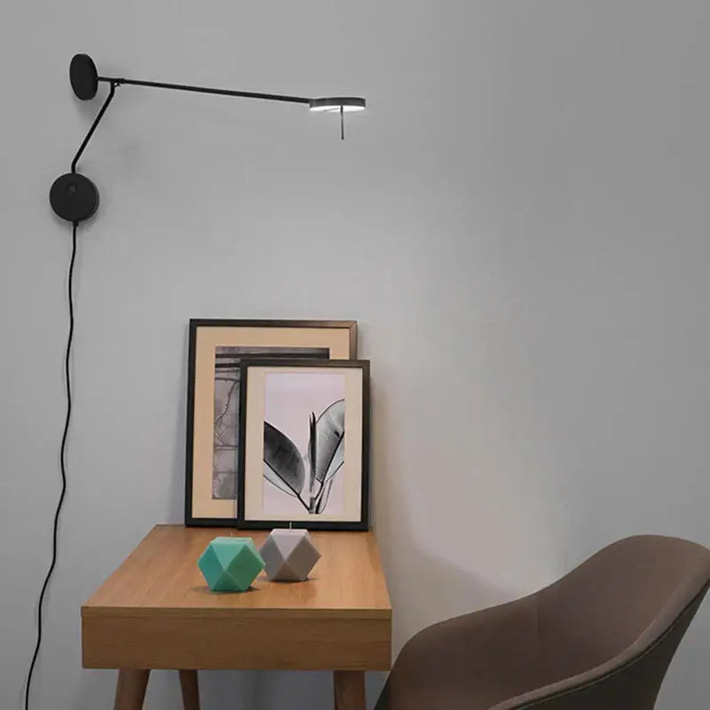 Minimalist black wall lamp with adjustable swing arm for bedroom featuring sleek modern design and wall-mounted installation
