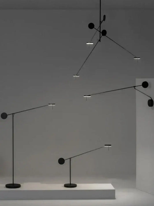 Black minimalist pendant and floor lamps featuring sleek adjustable swing arms and circular light fixtures