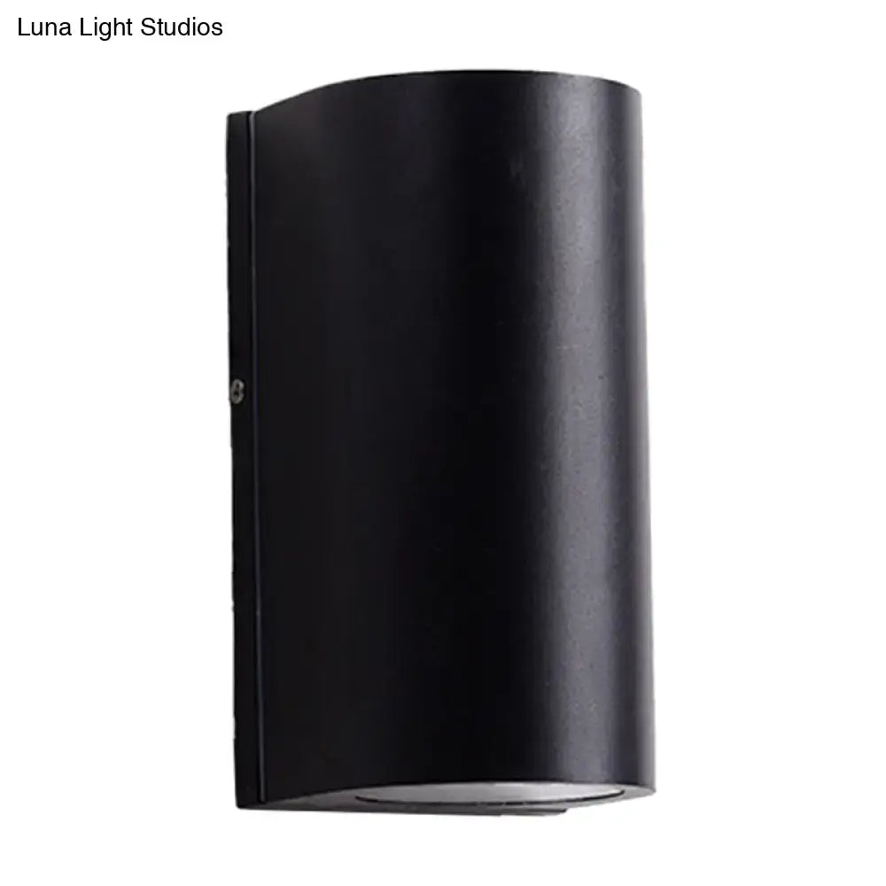 Minimalist black aluminum cylindrical wall light with matte finish for direct wired electric outdoor space use
