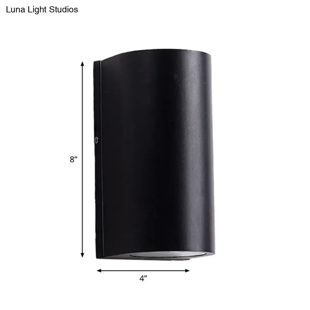 Minimalist black aluminum outdoor cylinder wall light 8 inches tall direct wired electric for outdoor space