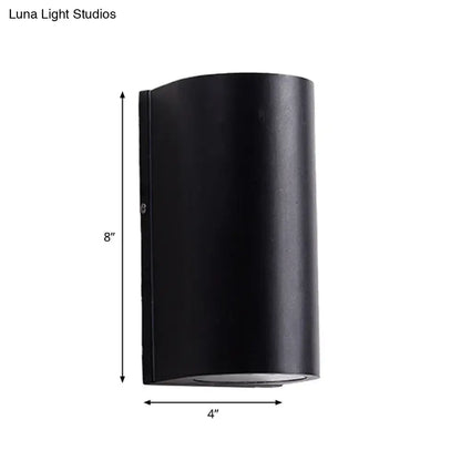Minimalist black aluminum outdoor cylinder wall light 8 inches tall direct wired electric for outdoor space