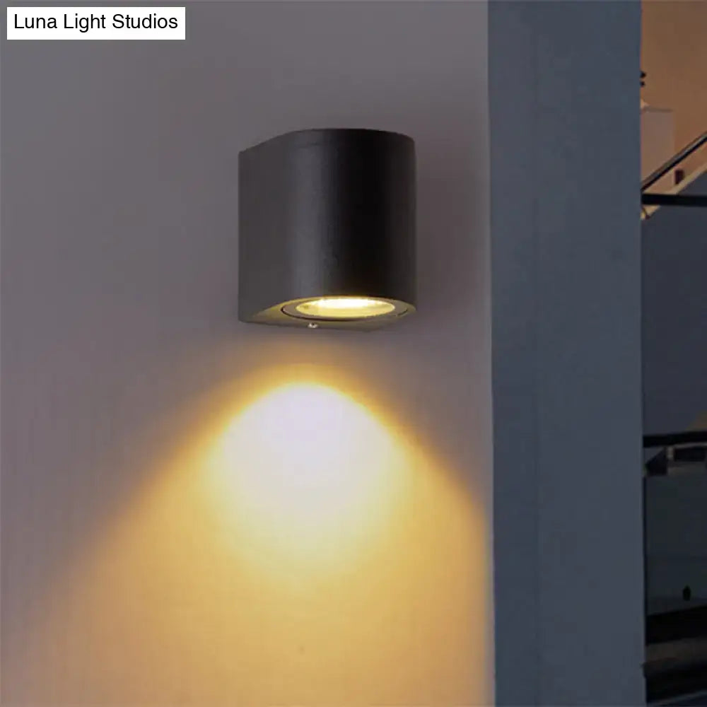 Modern matte black cylindrical wall light made of aluminum with direct wired electric for outdoor space lighting
