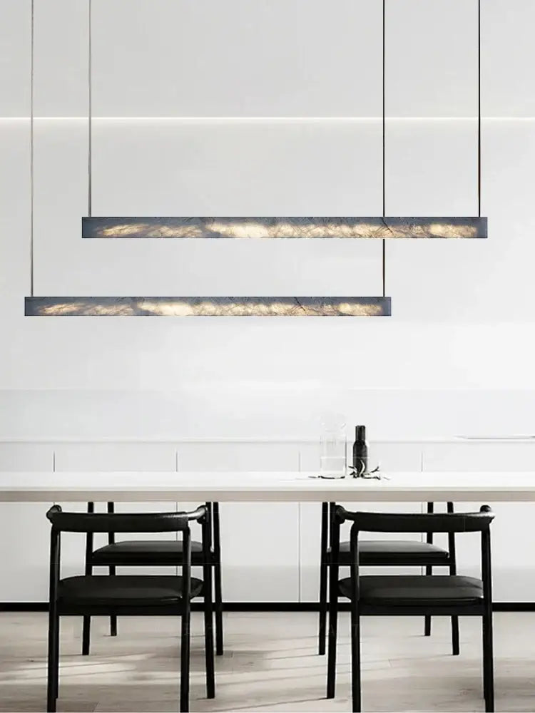 Minimalist black and amber marble design pendant light with sleek frame and warm interior illumination for office use