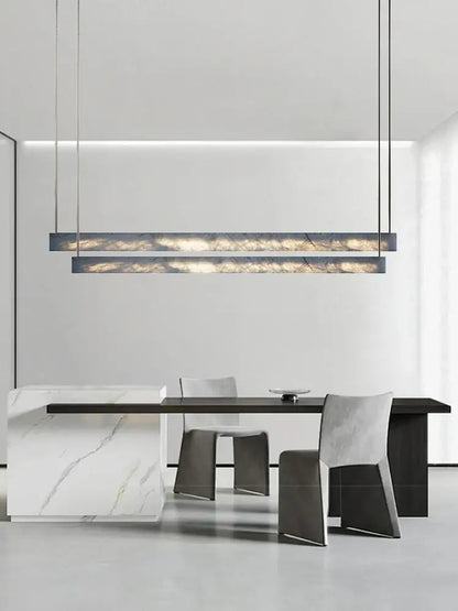Minimalist black and amber marble design pendant light with sleek rectangular shape and dark metal frame for office use
