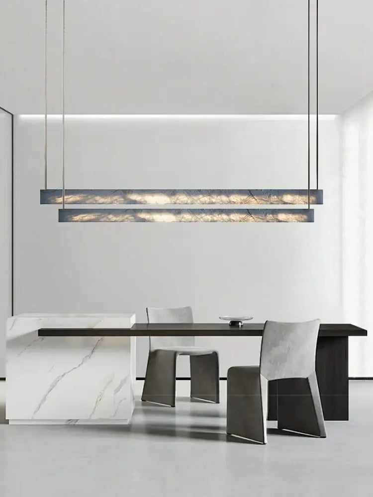 Minimalist black and amber marble design pendant light with sleek rectangular shape and dark metal frame for office use
