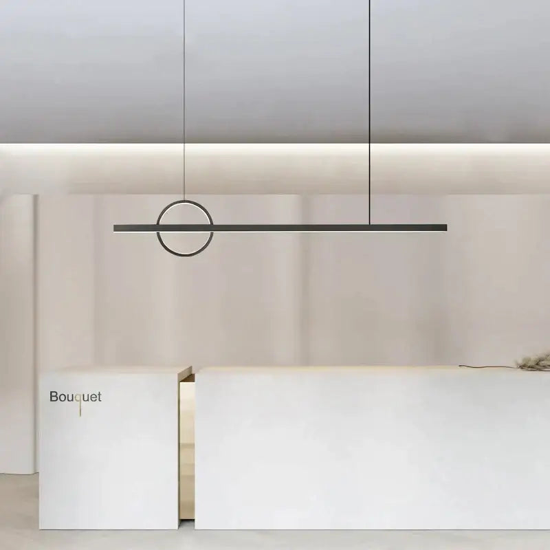 Minimalist black and geometric copper chandelier dining room light with circular accent above white reception desk decorbites geometric copper