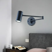 Minimalist black gold adjustable cylinder wall light with black matte finish and articulated arm for bedroom reading