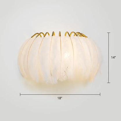 Minimalist black and gold feather wall sconce with soft white feathers and golden metal rim light type fixture height included