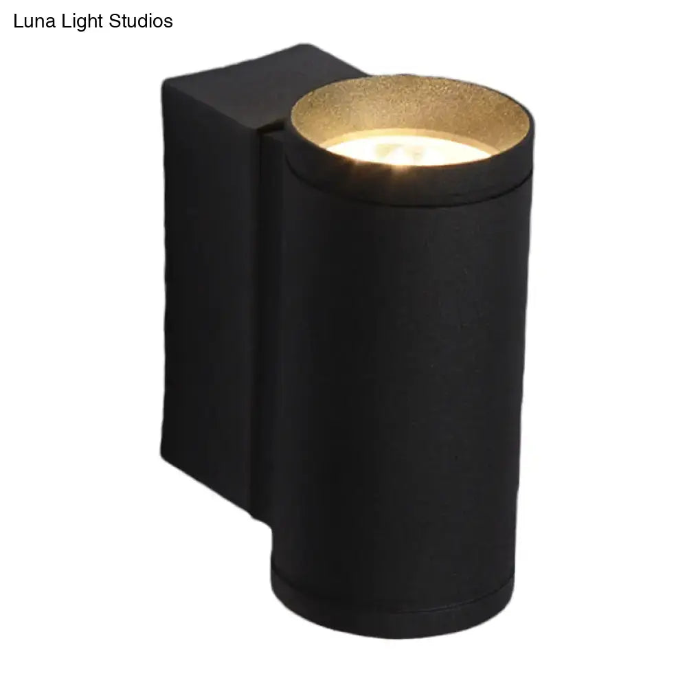 Minimalist black and gold metal wall mounted lamp with cylindrical design and warm illumination for bedroom use