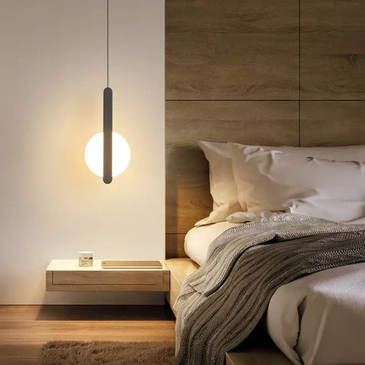 Minimalist black and white led pendant light with sleek cylindrical frame and warm white diffuser for contemporary interiors