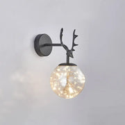 Minimalist black metal deer head wall sconce with glass globe housing warm fairy lights for bedroom decor