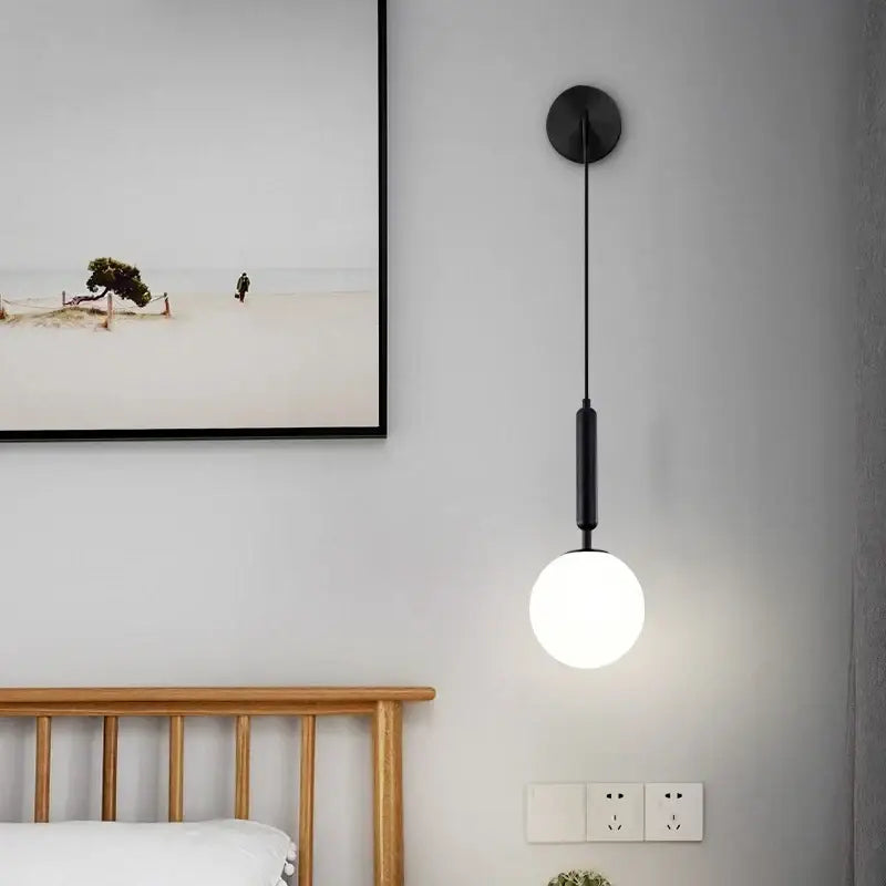 Minimalist black wall lamp with matte glass ball and brass accents perfect for bedroom decorbites glass ball wall lighting