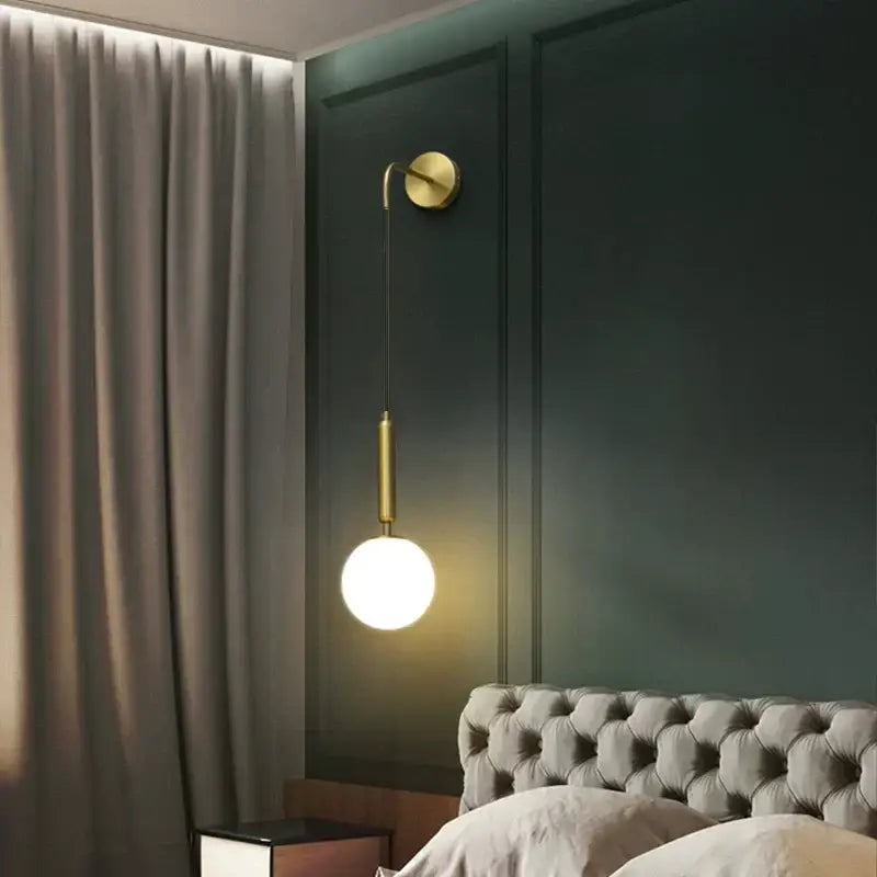 Minimalist black and brass wall lamp with gold-toned stem and frosted glass globe glass ball wall for bedroom decorbites glass ball