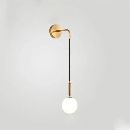 Gold-toned minimalist wall lamp with curved arm, black cord, and frosted decorbites glass ball globe for bedroom decor