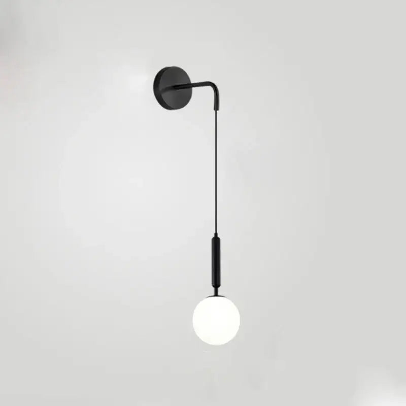 Minimalist black wall lamp with brass accents and frosted glass ball for bedroom decorbites glass ball wall lighting