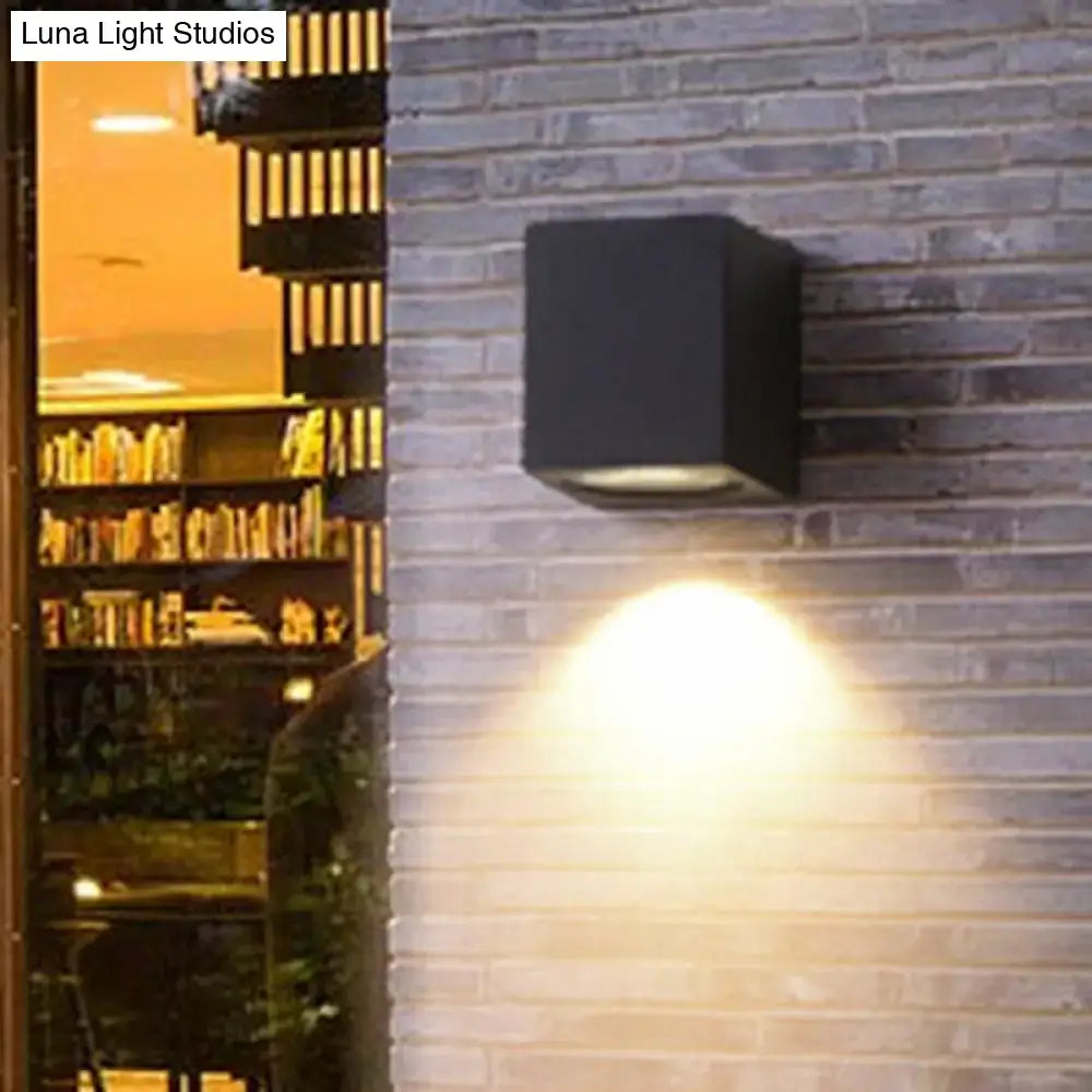 Minimalist black and brass led flush mount wall sconce with warm focused light beam for corridor lighting