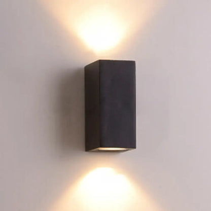 Minimalist black and brass led flush mount wall sconce with dual upward and downward lighting for corridor use