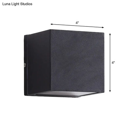Minimalist black and brass led flush mount wall sconce with a textured 4-inch cube design for outdoor corridor lighting