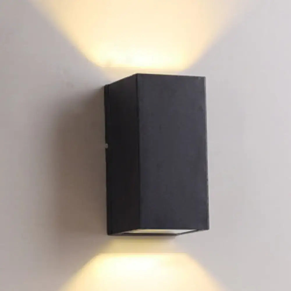 Black rectangular led flush mount wall sconce with brass accents and two angled light beams for minimalist corridor lighting
