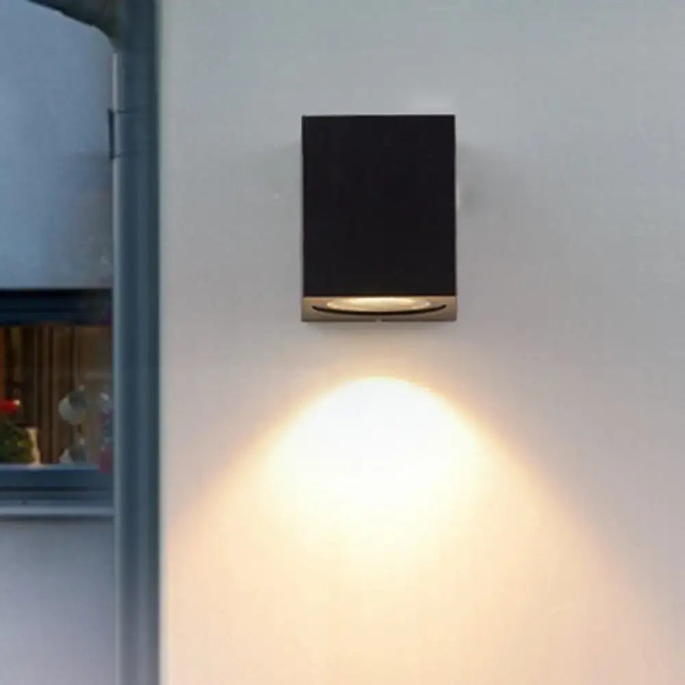 Minimalist black and brass led flush mount wall sconce with brushed brass accent and warm focused corridor lighting