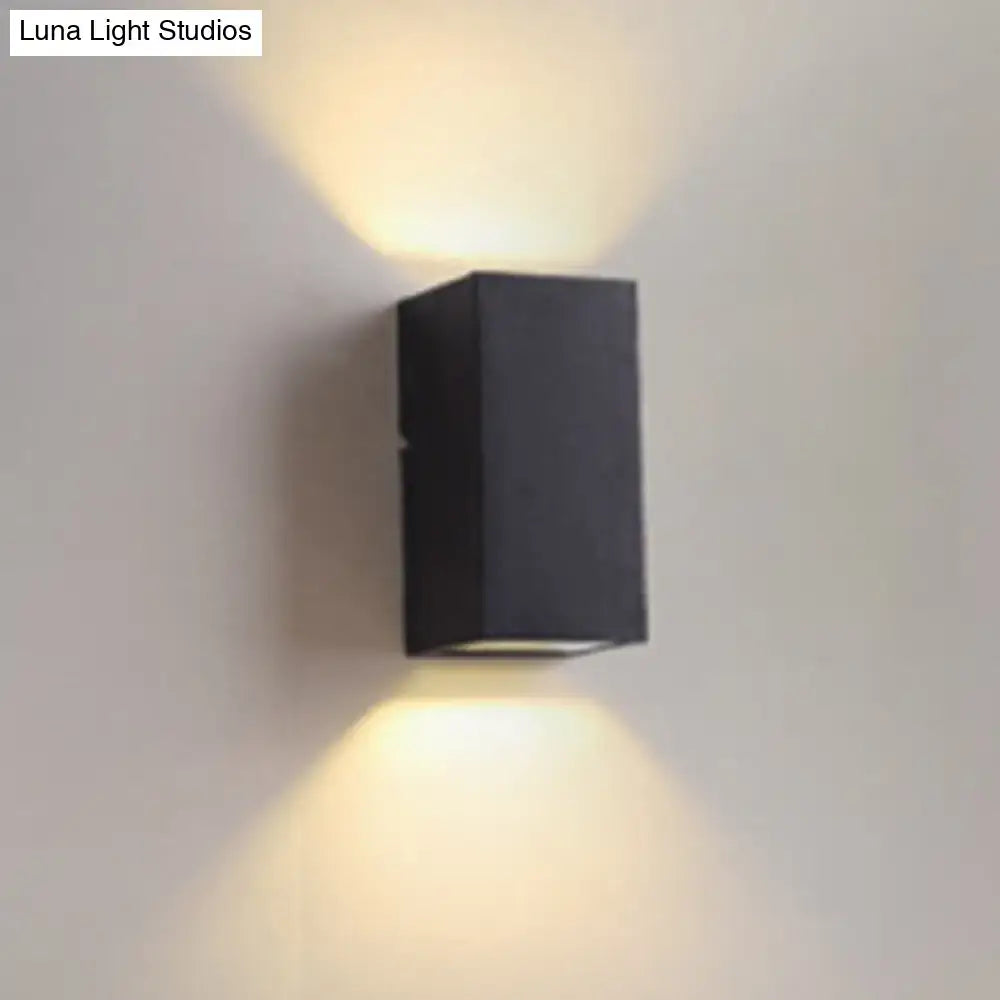 Minimalist black and brass led flush mount wall sconce with modern design emitting warm focused light for corridors