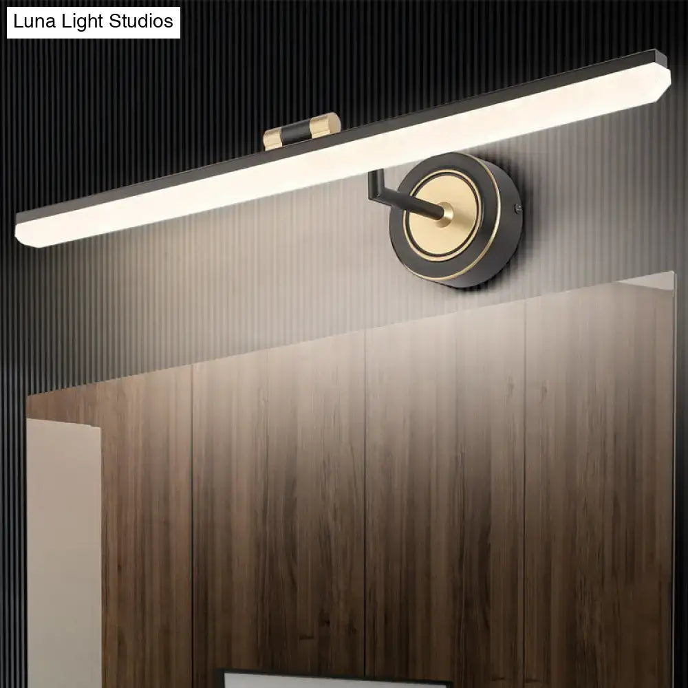 Minimalist black and brass wall mounted vanity light with sleek rectangular design and adjustable spotlight for targeted illumination