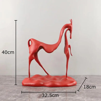 Vibrant red abstract sculpted deer figurine with glossy finish paired with minimalist black decorbites cast iron horse sculpture