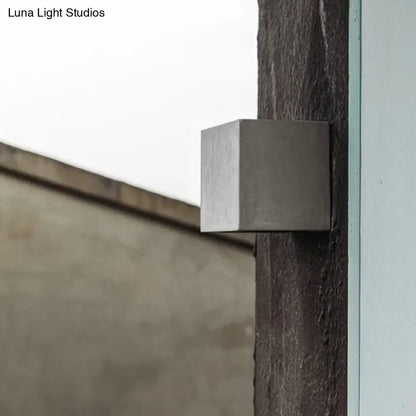 Minimalist black cement led wall lamp with a sleek matte metallic cube design for outdoor living room lighting