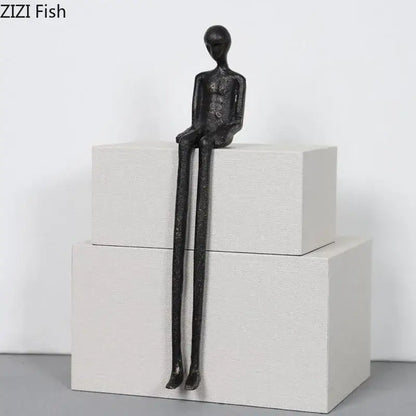 Minimalist black character metal statue with elongated limbs and matte finish as a living room desk ornament