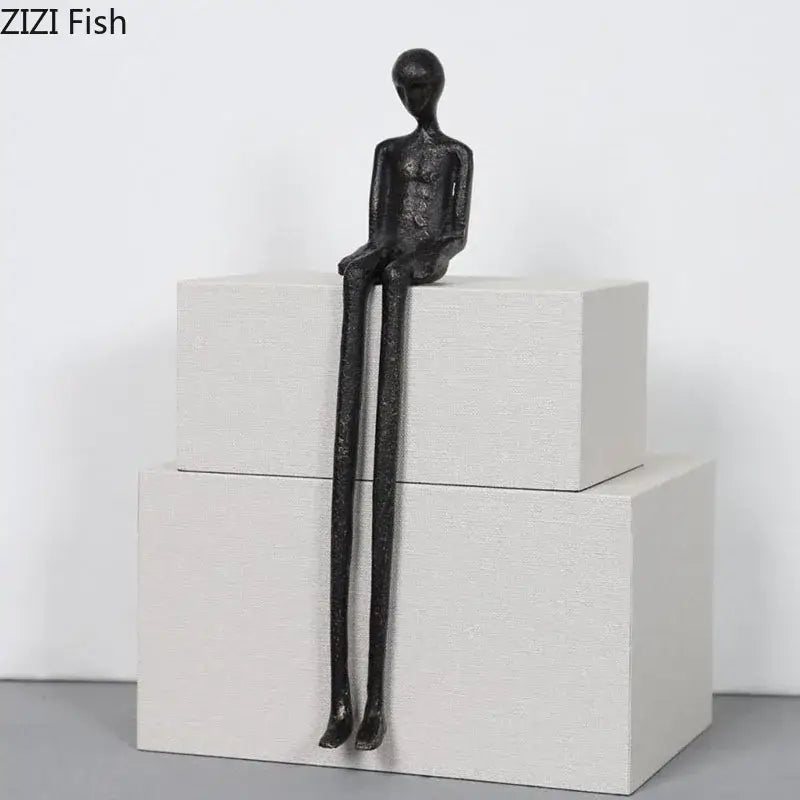 Minimalist black character metal statue with elongated limbs and matte finish as a living room desk ornament
