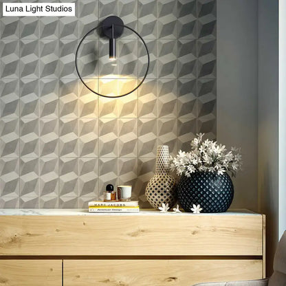 Minimalist black circular metal sconce with sleek design for living room wall lighting