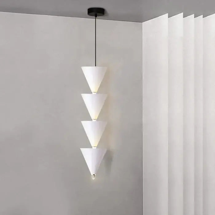White conical pendant light with four stacked illuminated segments in minimalist decorbites cream bedroom chandelier design