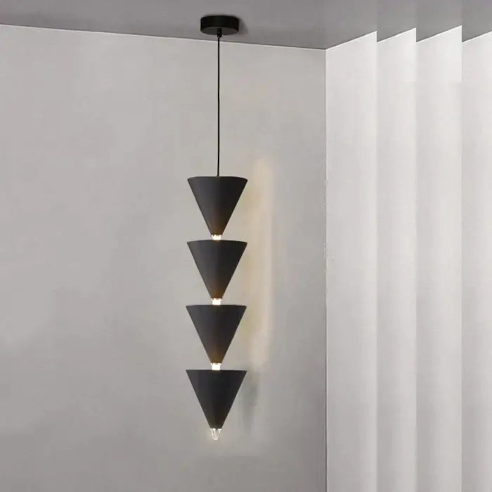 Minimalist black and cream bedroom chandelier featuring a black conical pendant light with four stacked geometric shades for decorbites cream bedroom