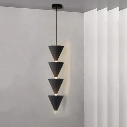 Minimalist black and cream bedroom chandelier featuring a black conical pendant light with four stacked geometric shades for decorbites cream bedroom