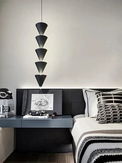 Minimalist black and cream bedroom chandelier with stacked conical pendant light above modern decorbites cream bedroom table