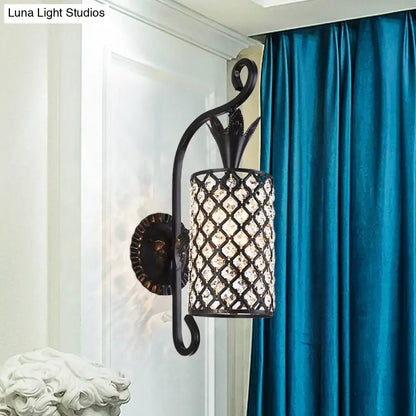 Minimalist black wrought iron wall sconce with cylindrical crystal lattice shade and ornate arm 110v-120v wall light